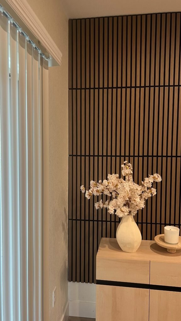 Slatted accent wall beside a window, completed by Home Repairman