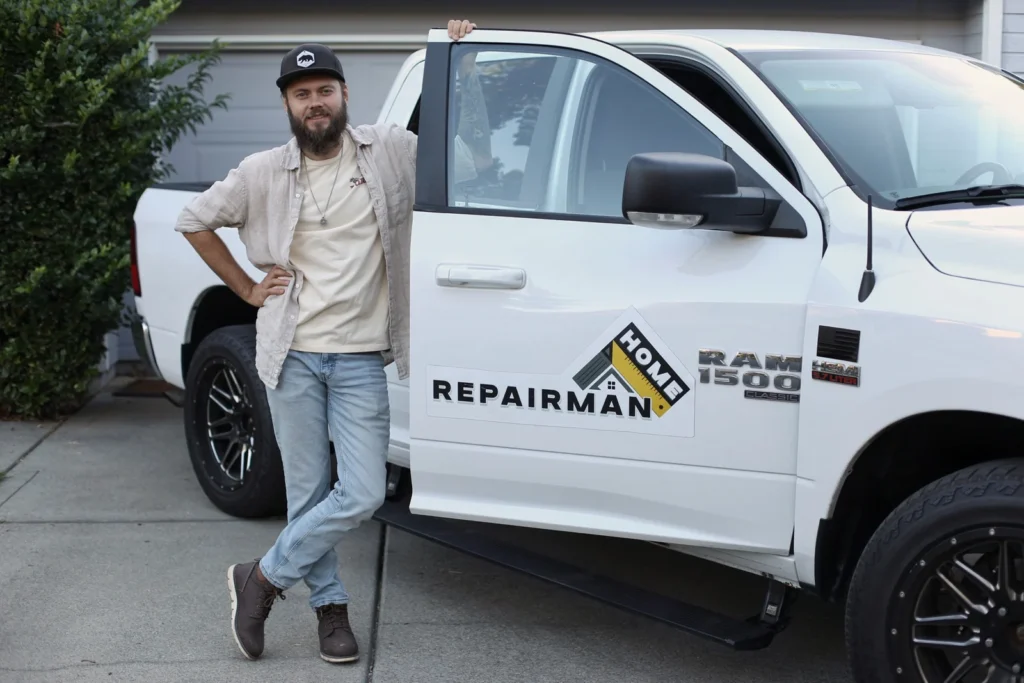 Alex Titov standing beside his branded Home Repairman truck