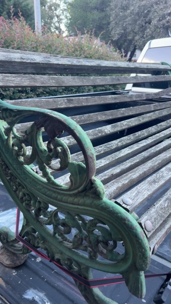 Garden bench with weathered wood slats before restoration