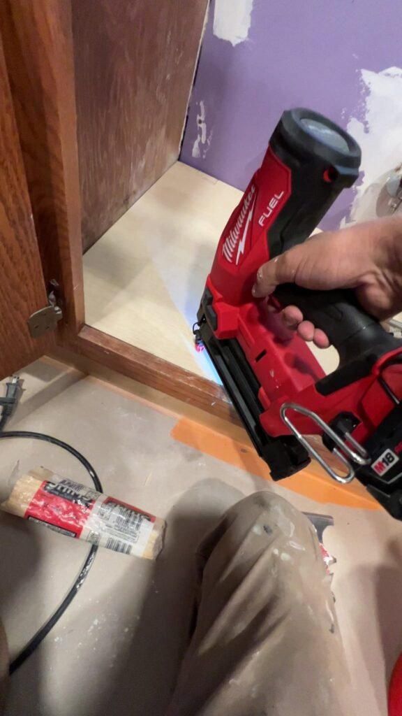 Fitting a replacement bottom panel inside a sink cabinet