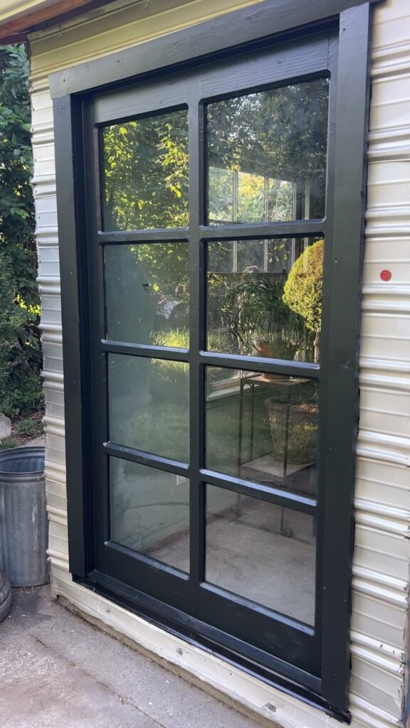 Finished dark wood window frame with divided sections
